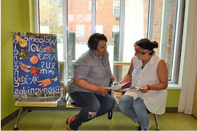 Attorney Catalina Martinez (left) meets with a pro bono client at an Advice & Referral Clinic